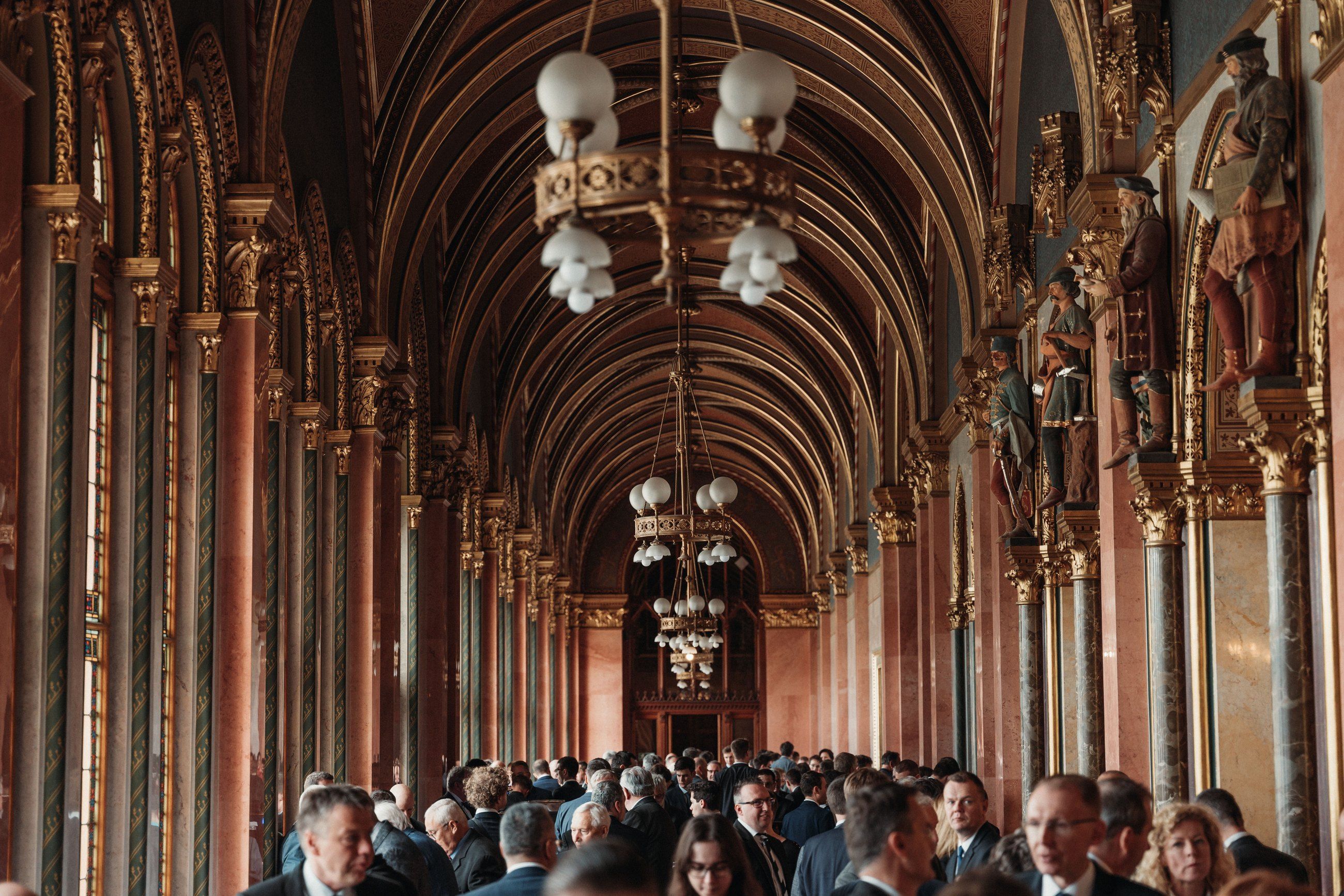 Guests gathered under a vaulted, gilded ceiling