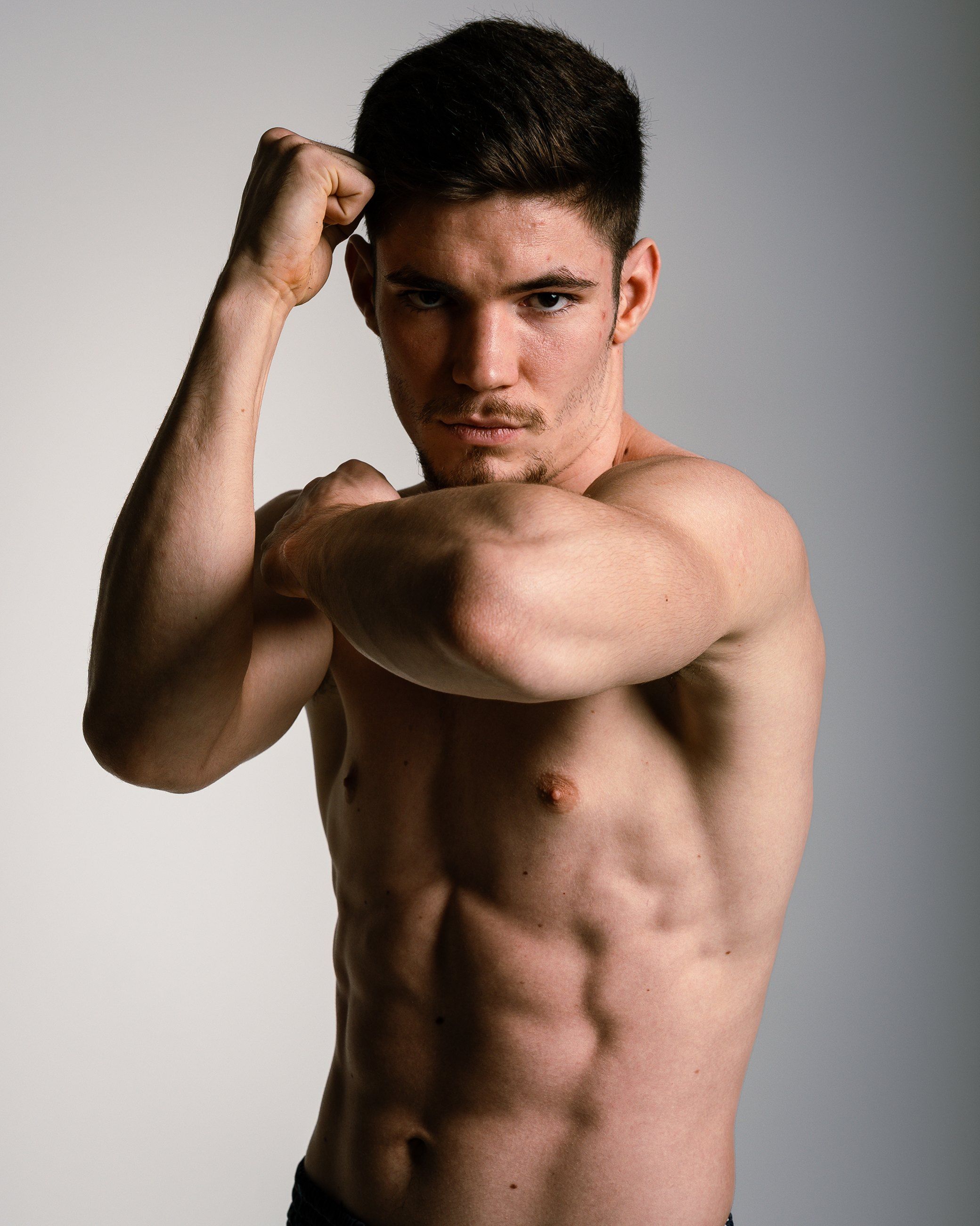 Shirtless fighter in a guard stance