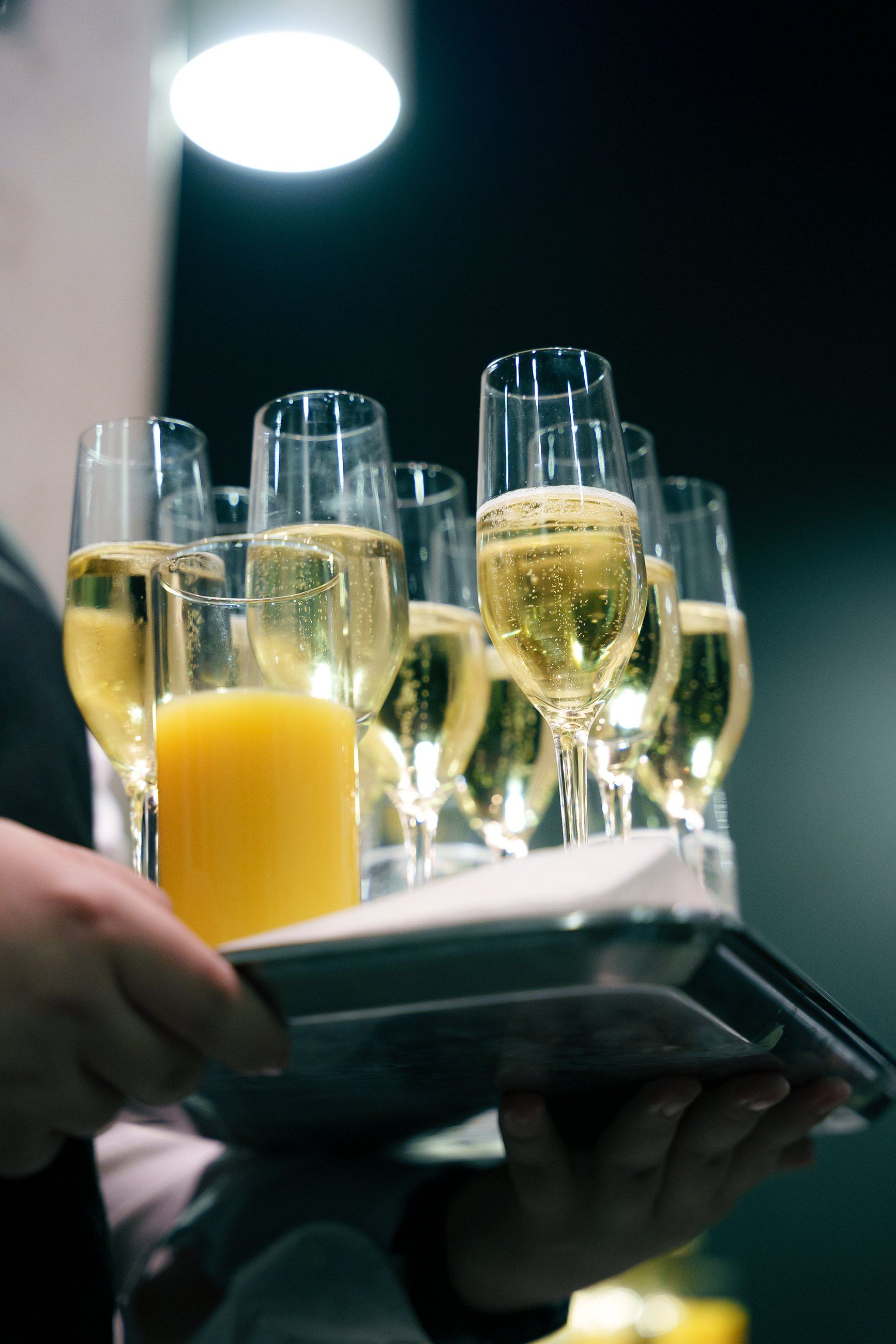 Tray of champagne glasses catching the light