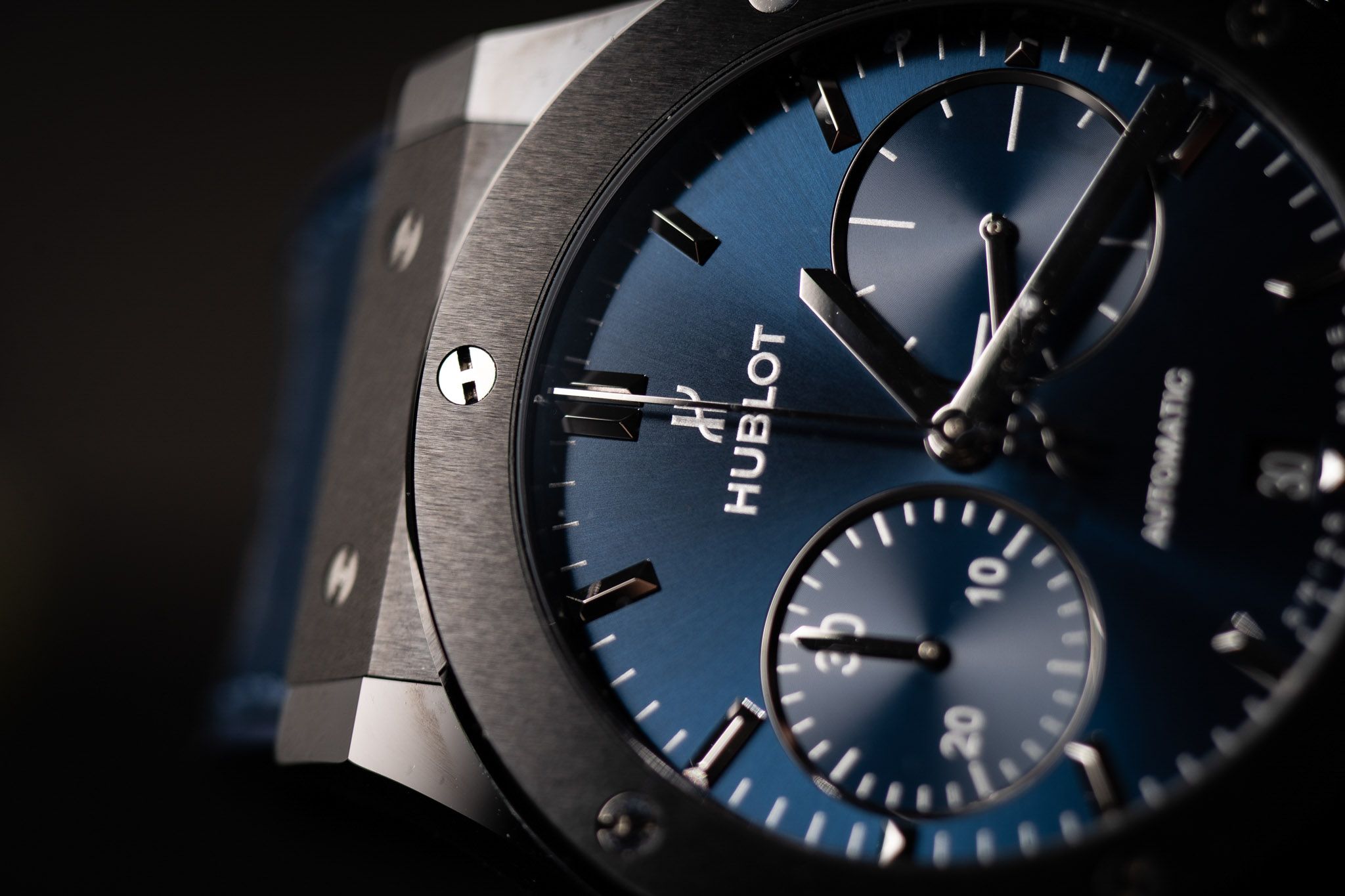 Hublot chronograph with a blue dial against a black backdrop