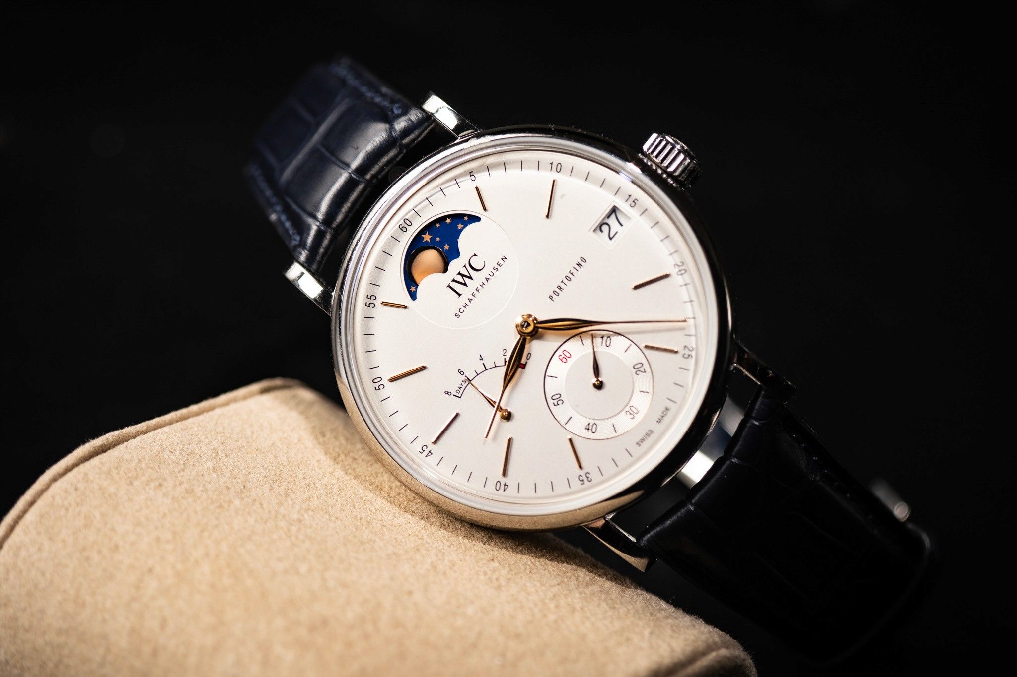 IWC moon-phase watch on a cream cushion