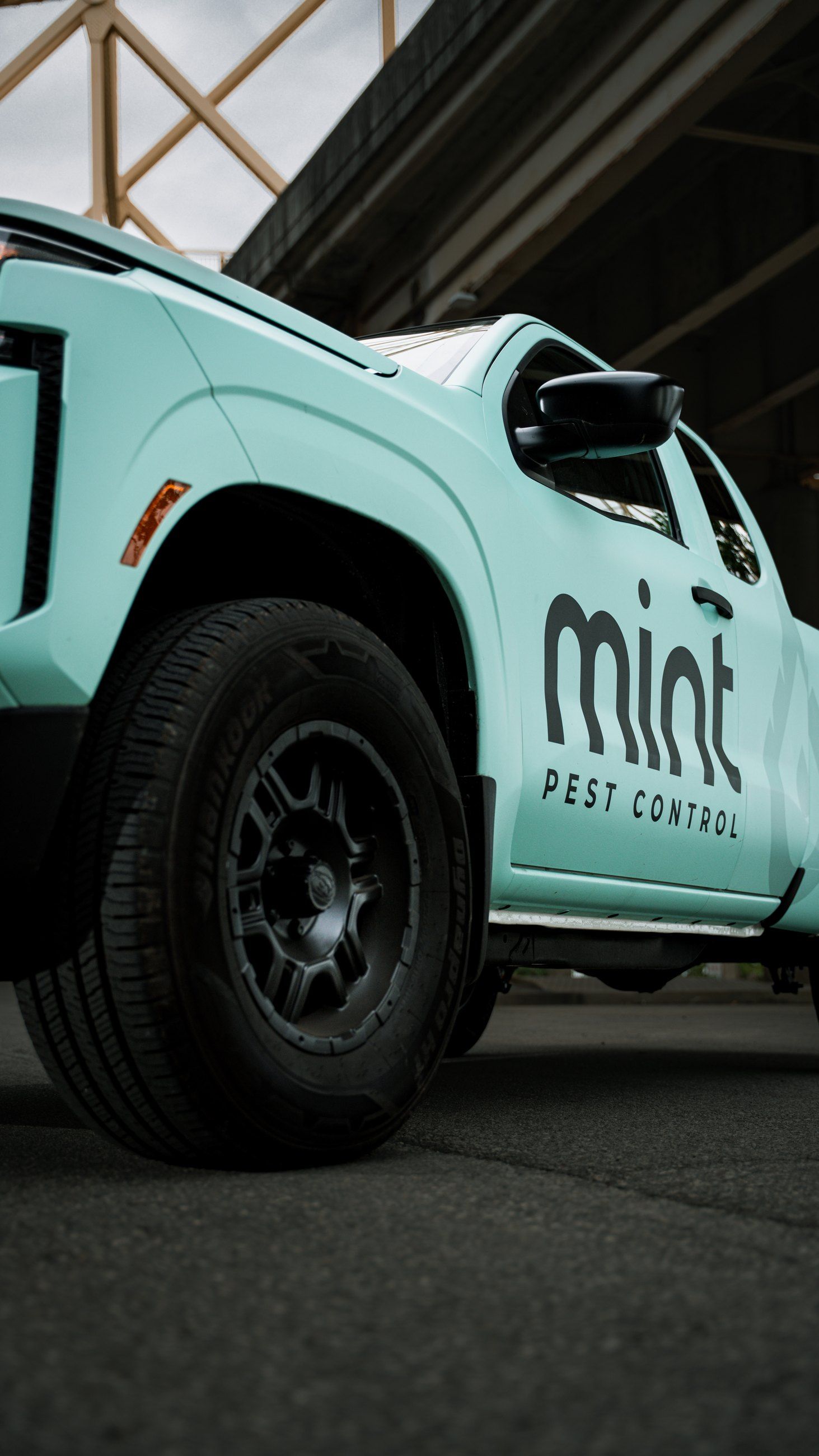 Low-angle close-up of a branded pickup door and wheel