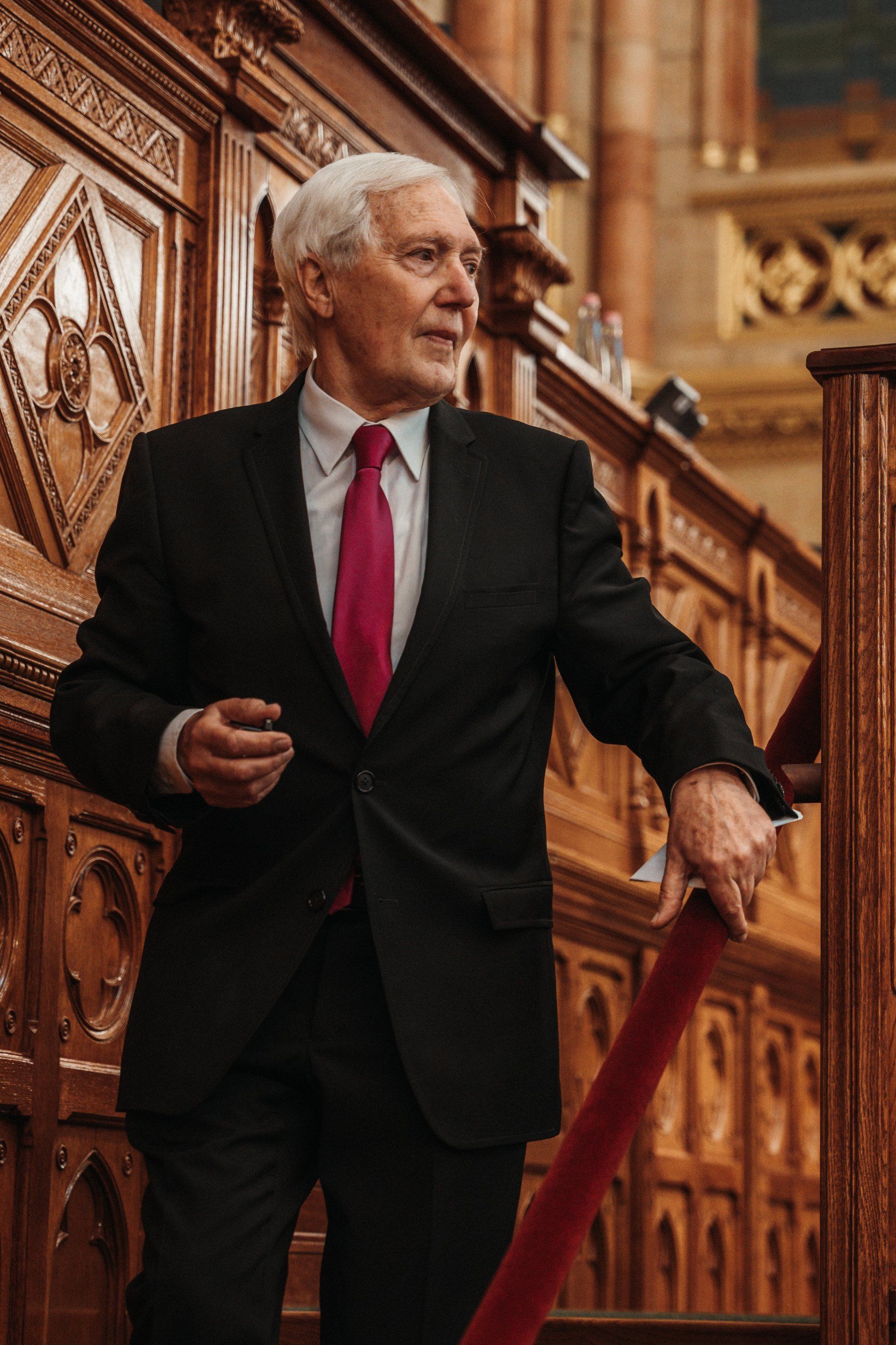 Guest pausing on a carved wooden staircase