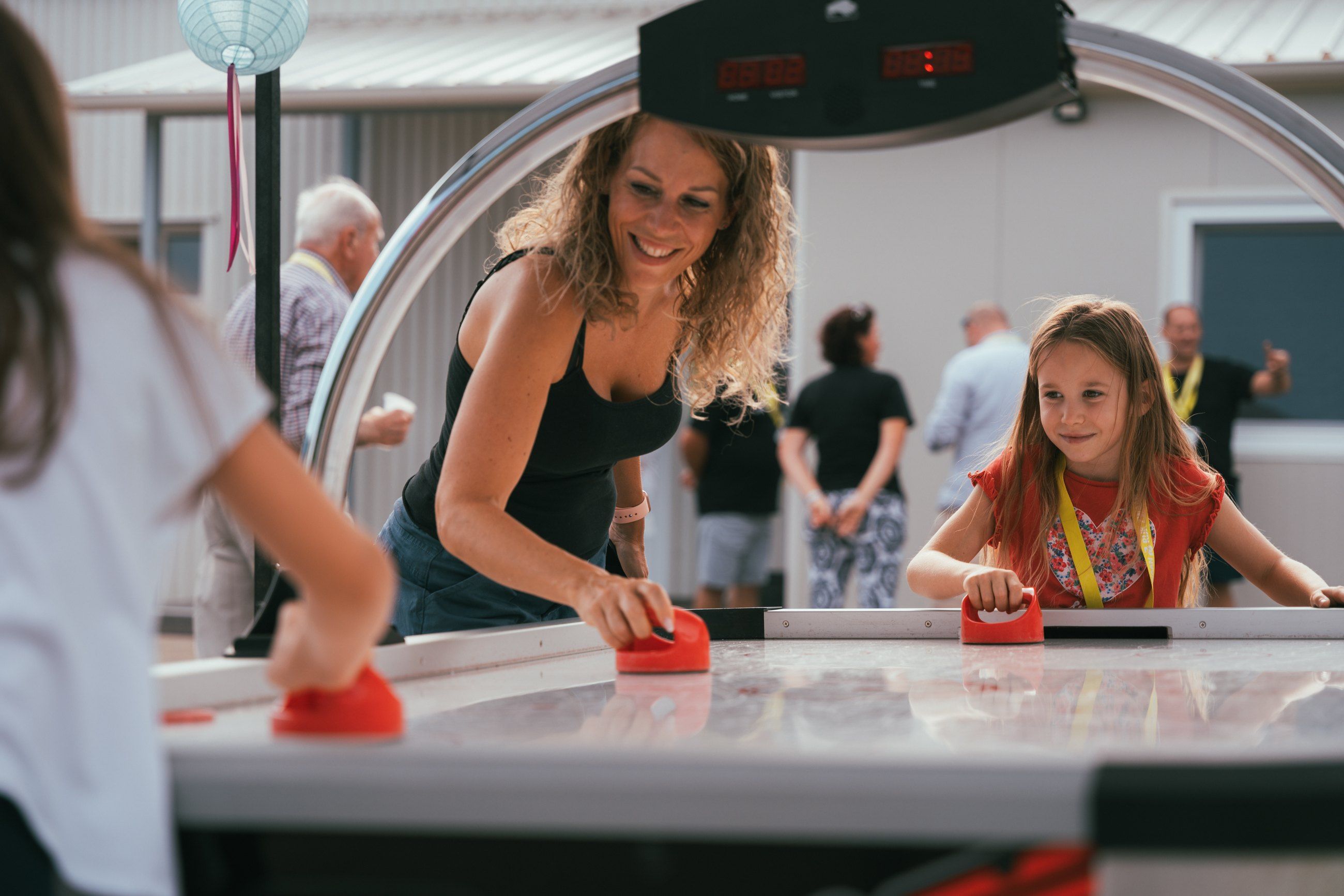Mother and daughter playing air hockey