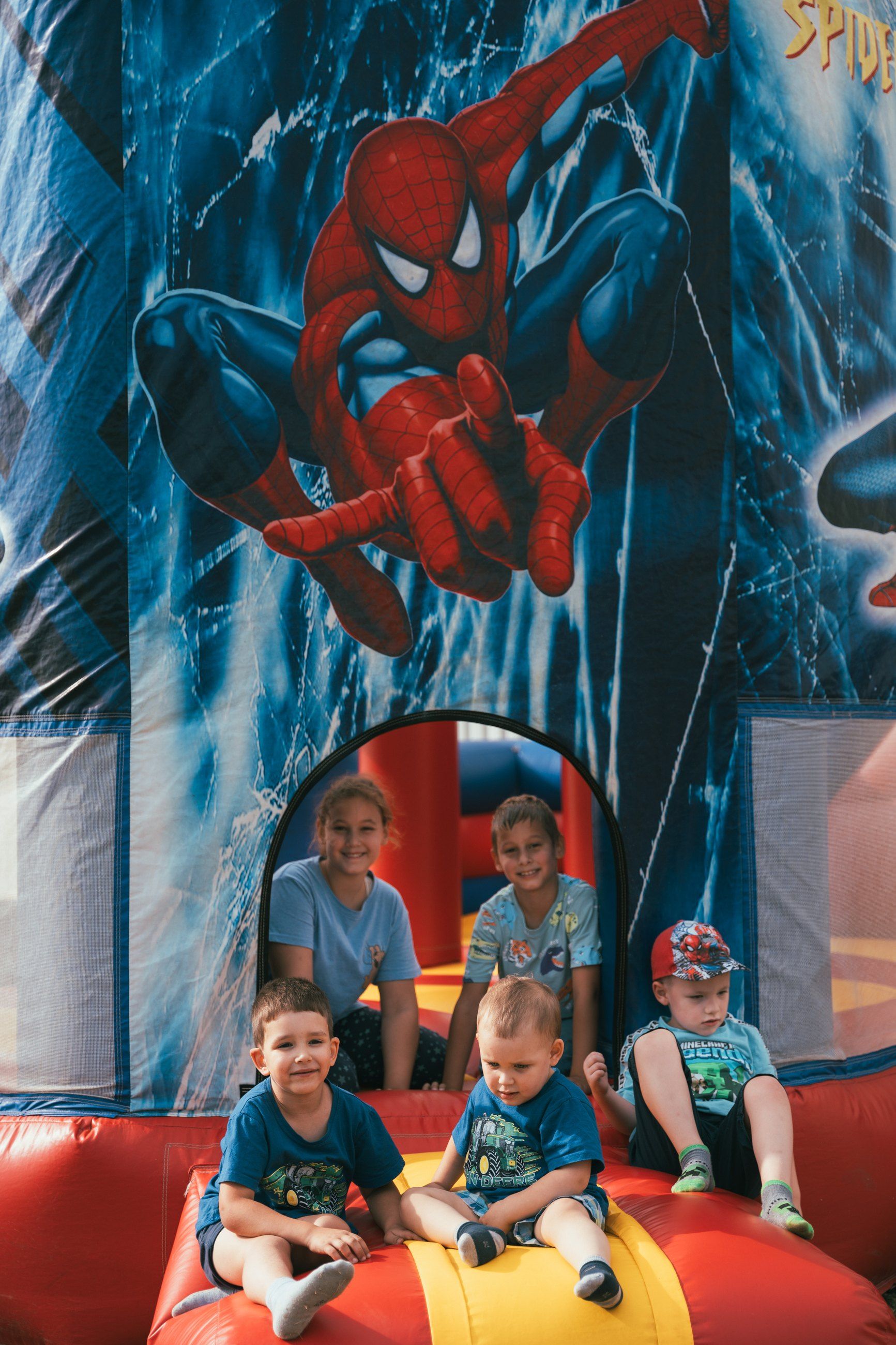 Kids in a Spider-Man bouncy castle