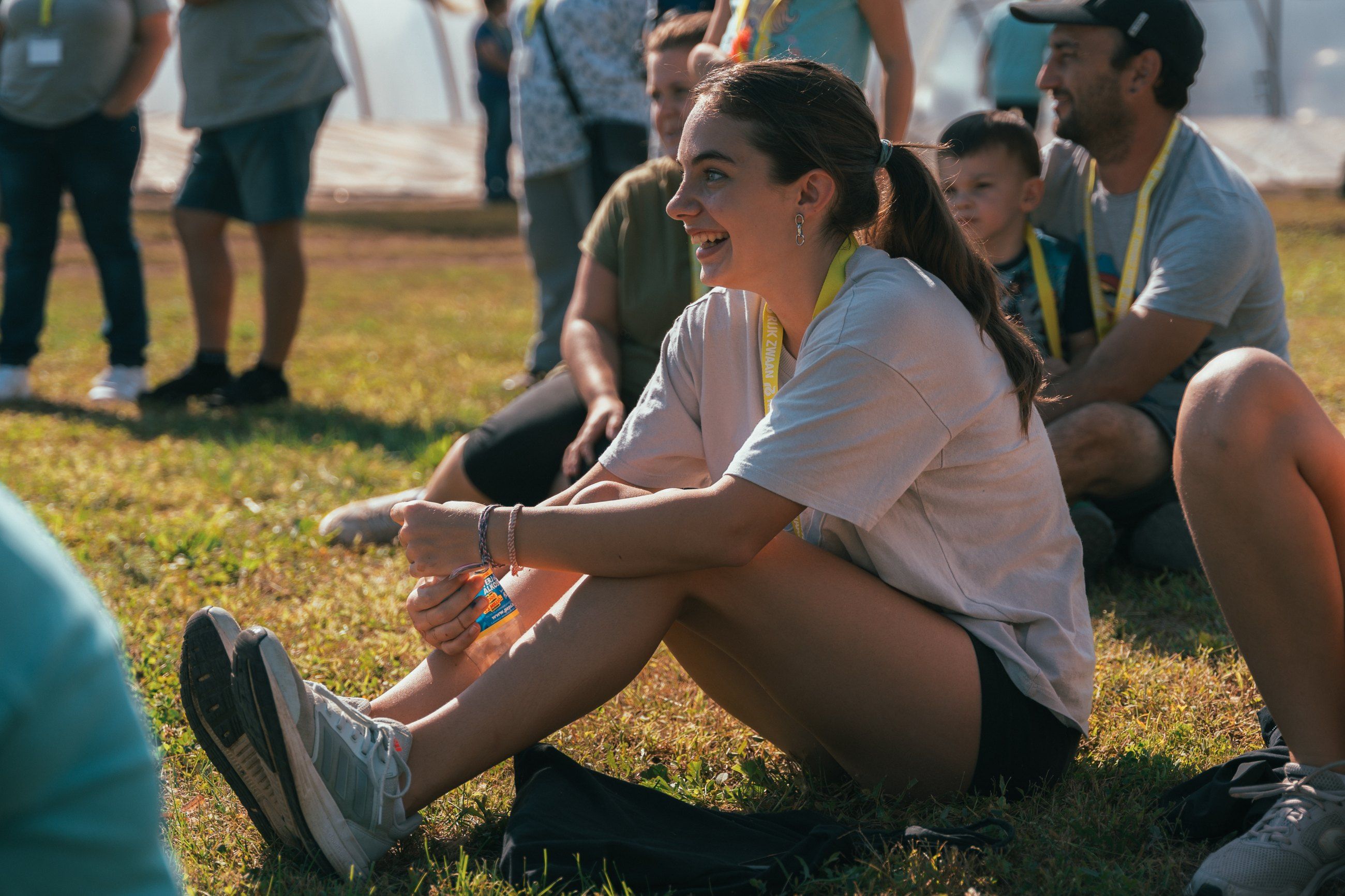 Guest laughing on the grass among the crowd