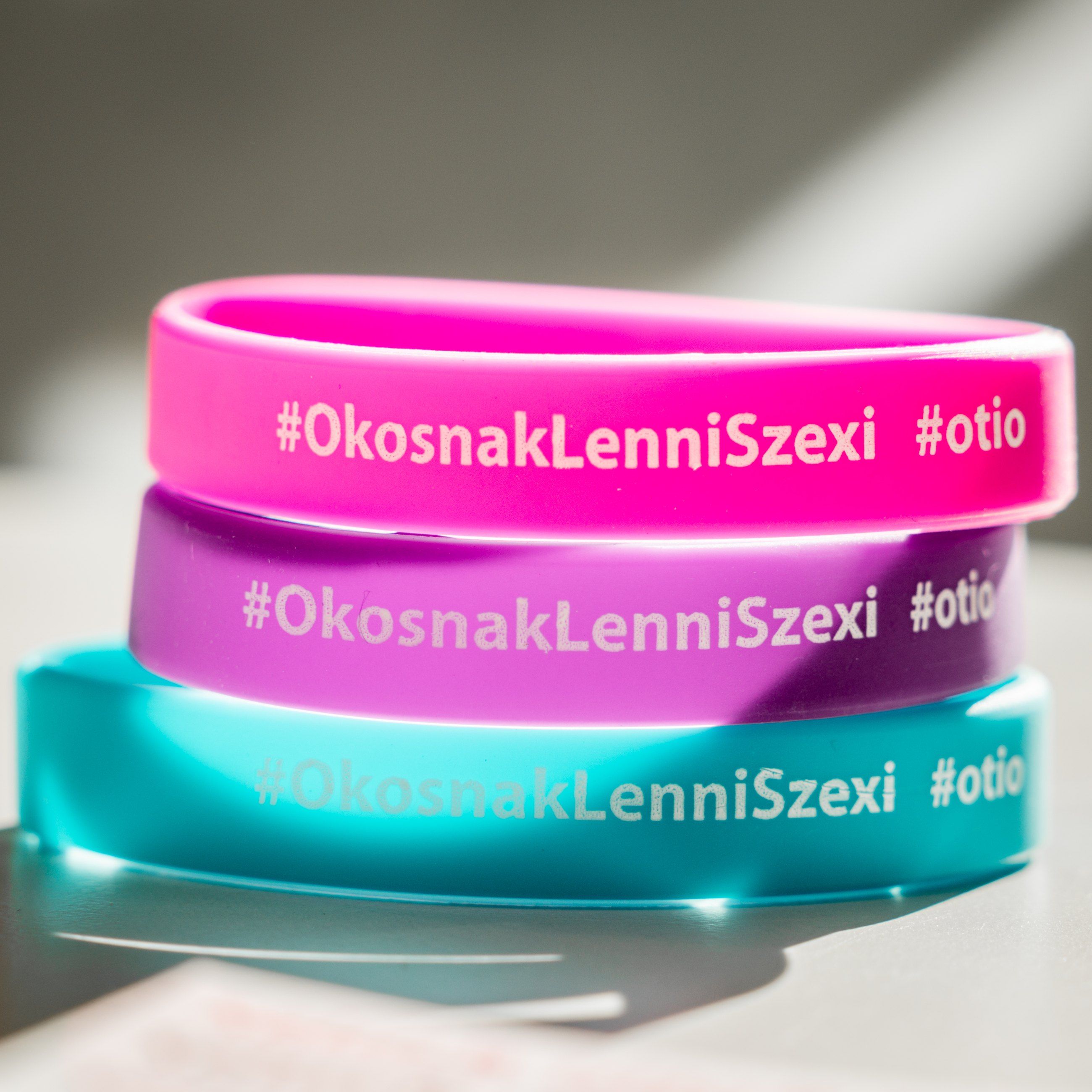 Branded silicone wristbands in pink, purple and teal