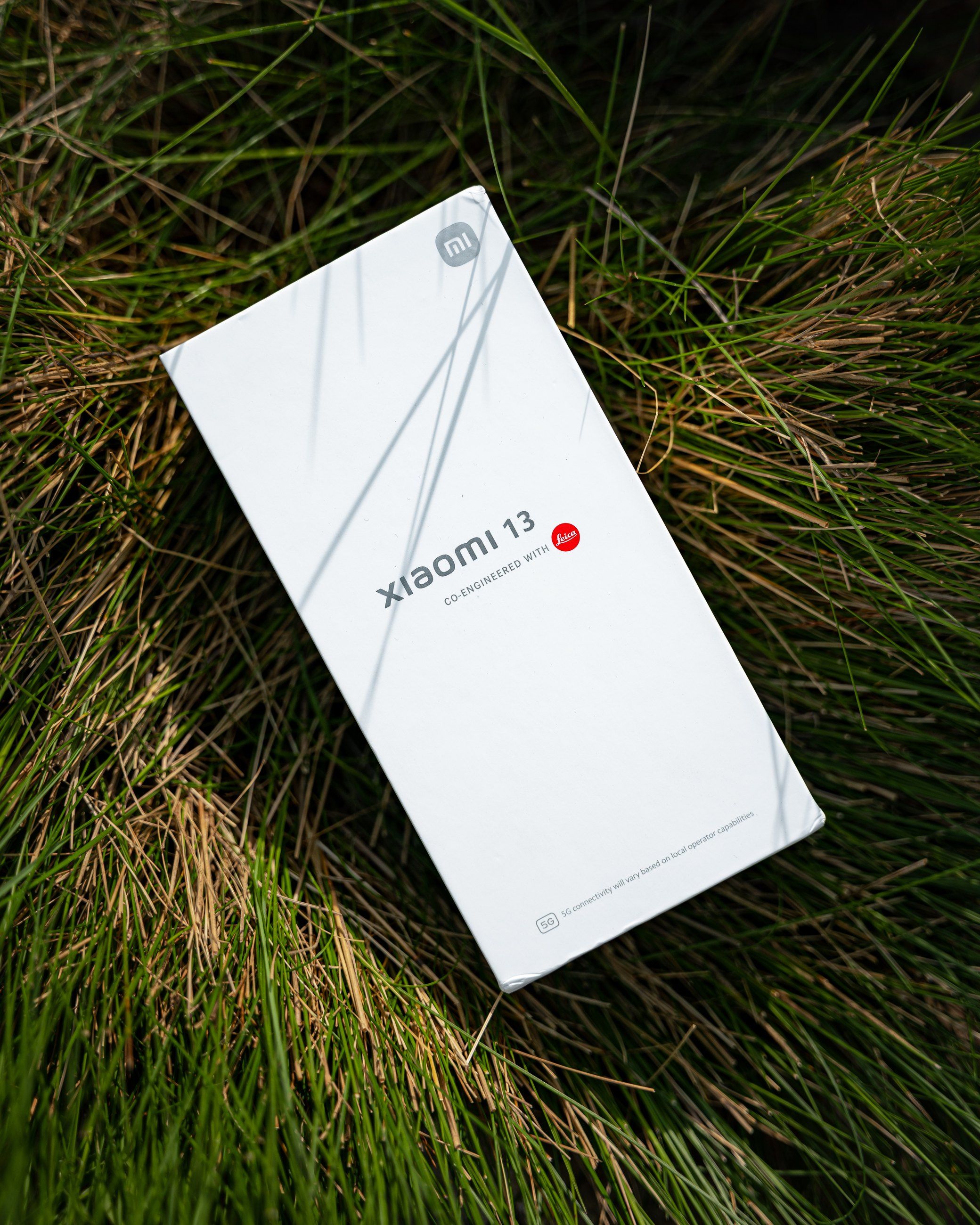 Xiaomi 13 box lying in long grass